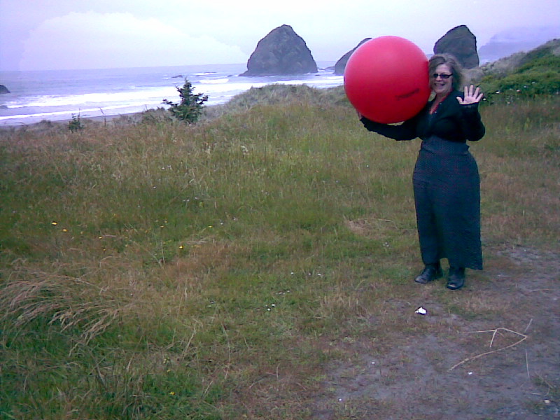 Annie with red ball by Pacific Ocean